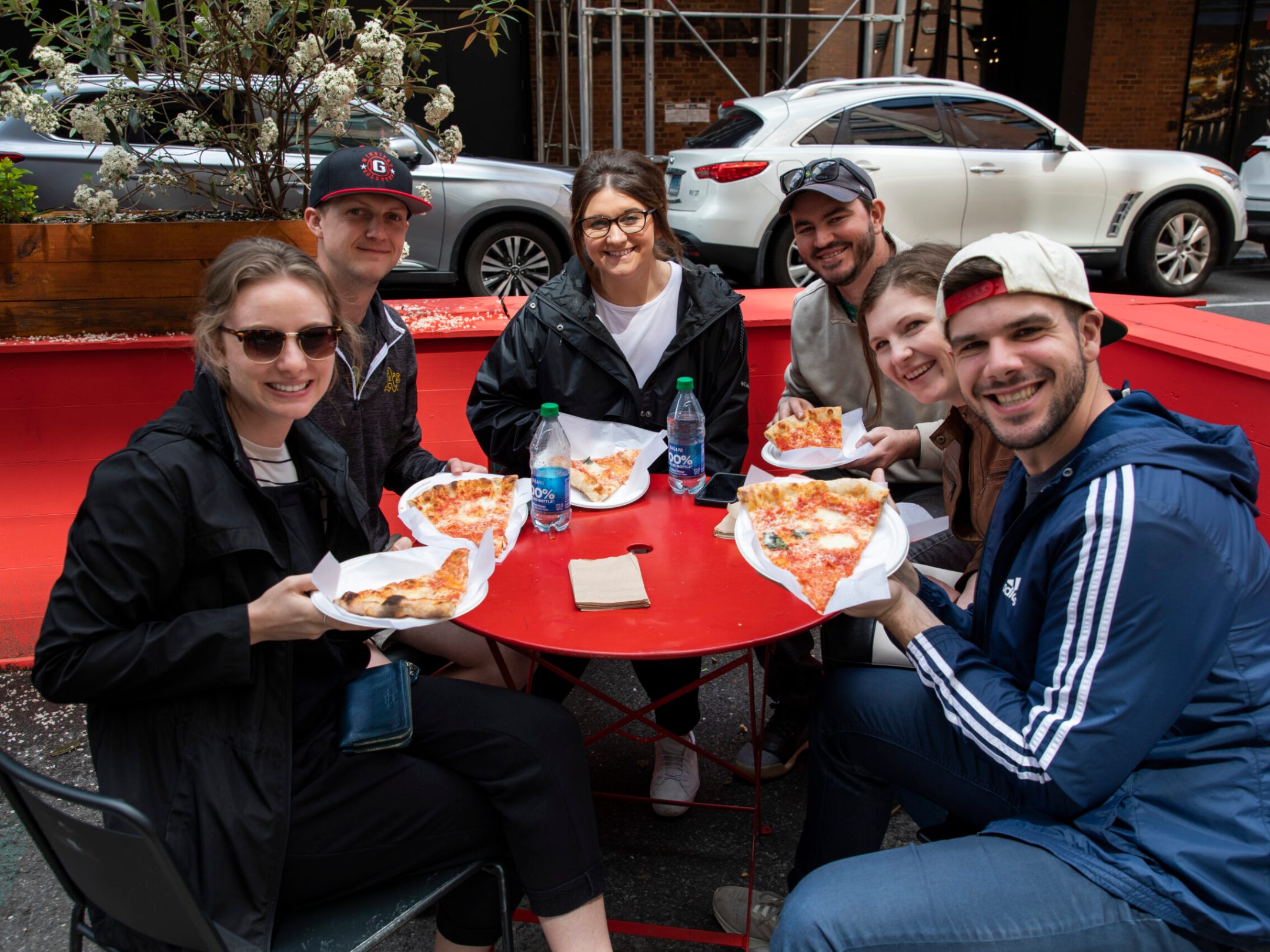 a group of people sitting at a table eating food