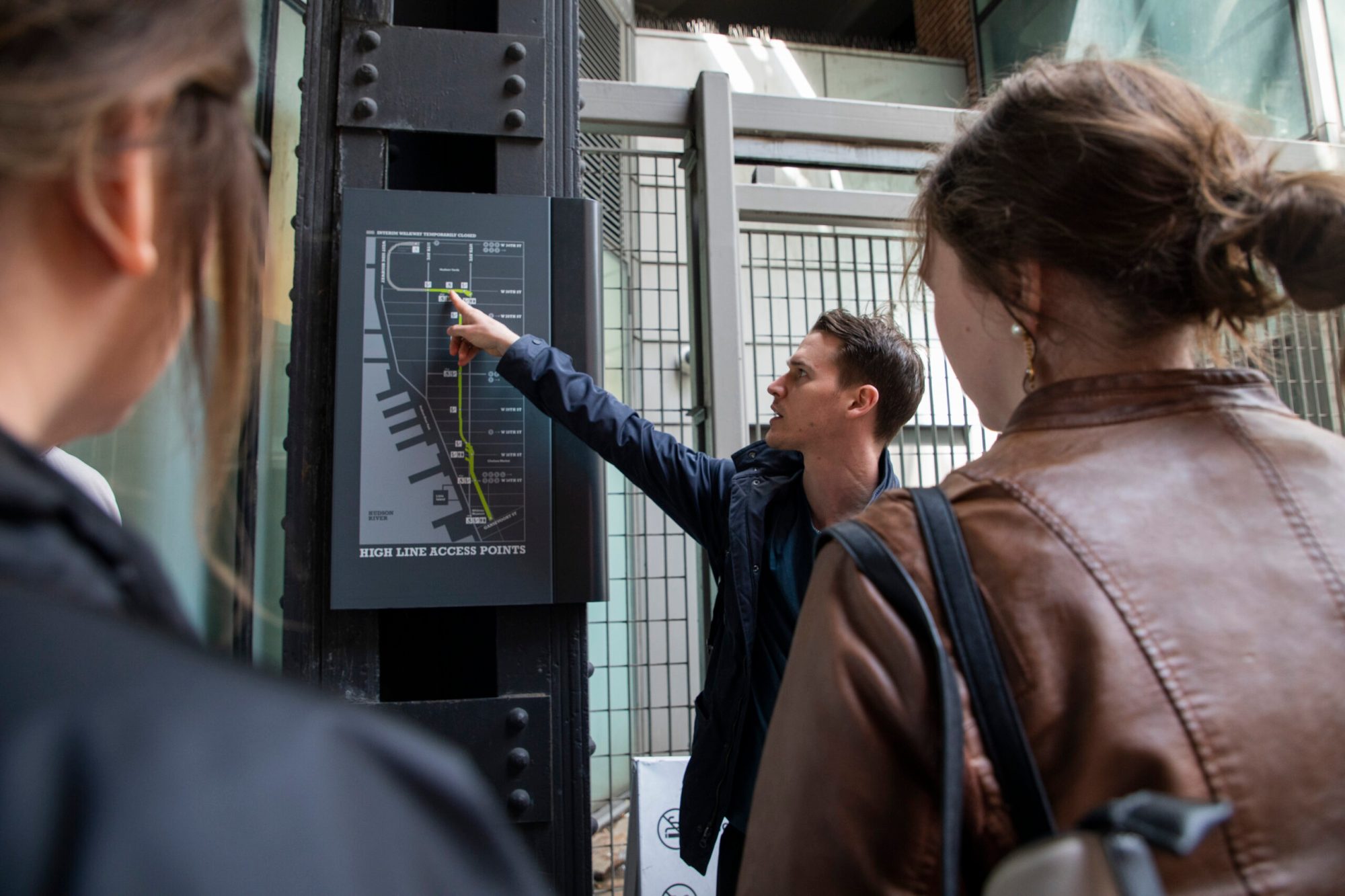 High Line Entrance NYC a man showing a group of people the map of the high line in nyc