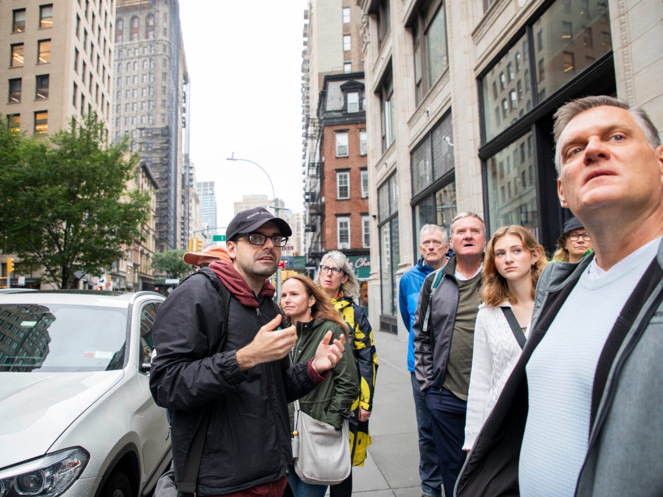 a group of people standing on a city street