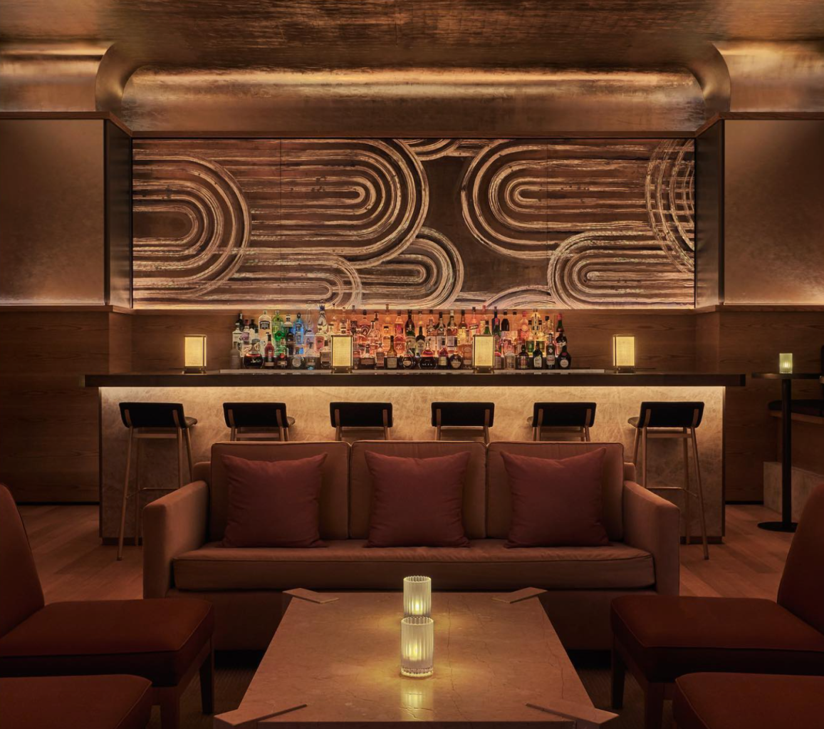 an art deco gold bar with bar stools