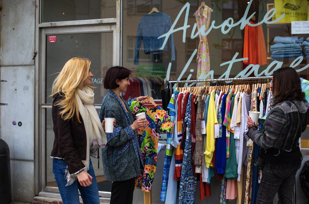 a group of people standing in front of a store