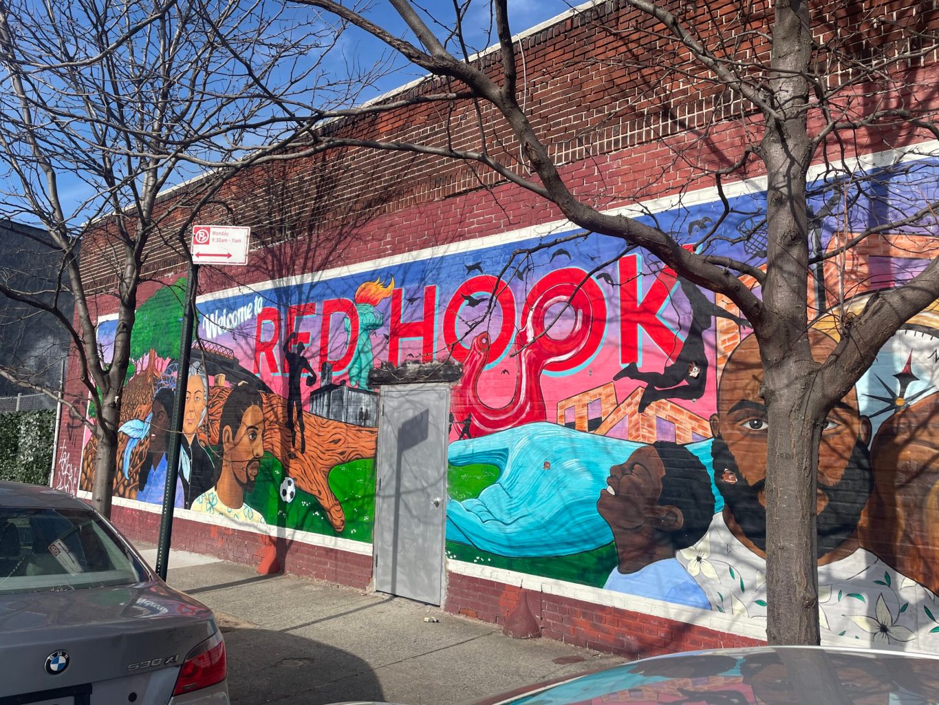 mural on a brick wall depicting a diverse group of people