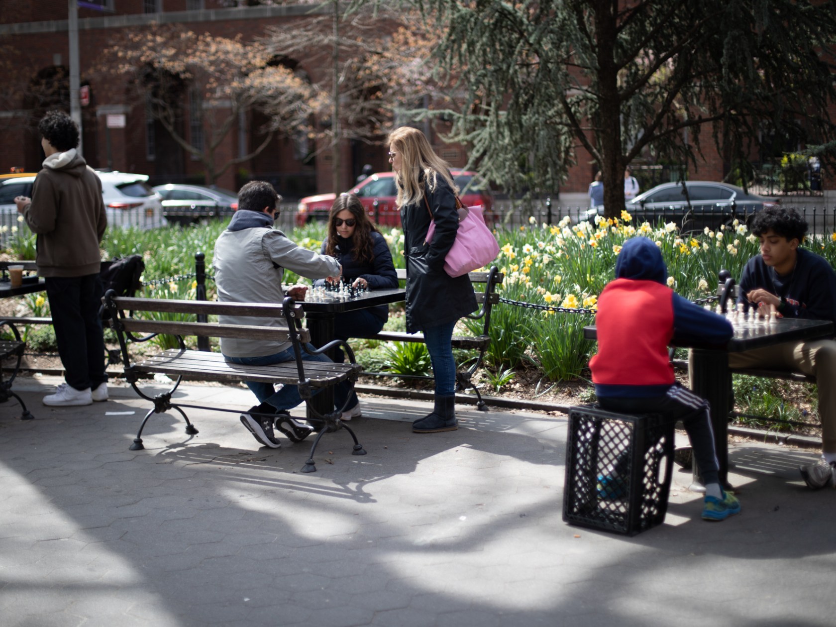 a group of people sitting on a park bench