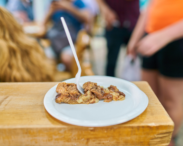 a woman sitting at a table with a plate of food
