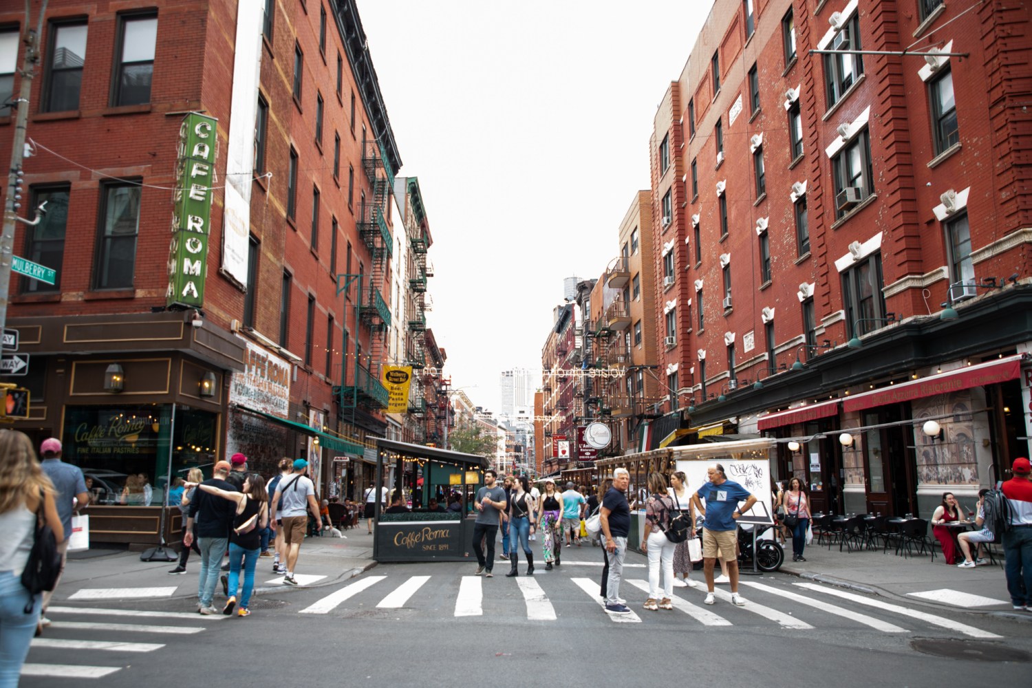 a group of people walking down a busy city street