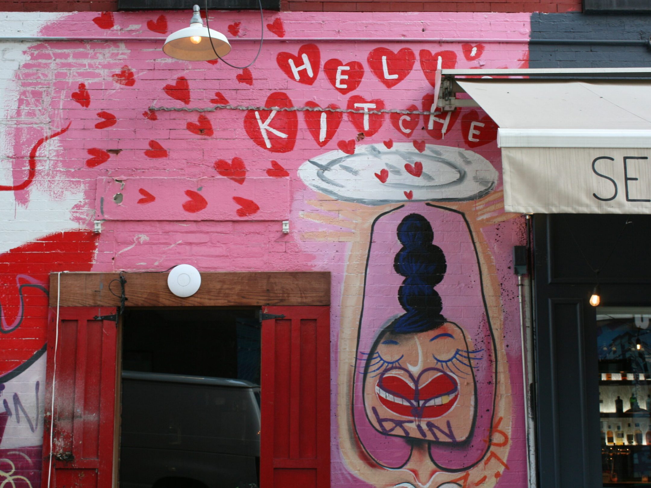 graffiti on a wall above a store