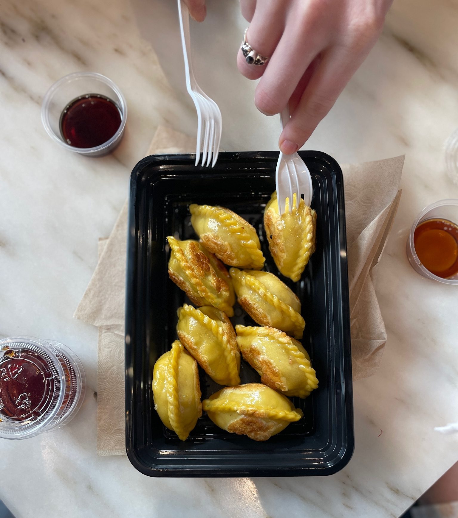 Nom Wah a person holding a tray of dumplings