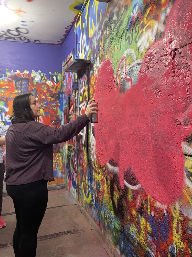 a person painting with spray paint