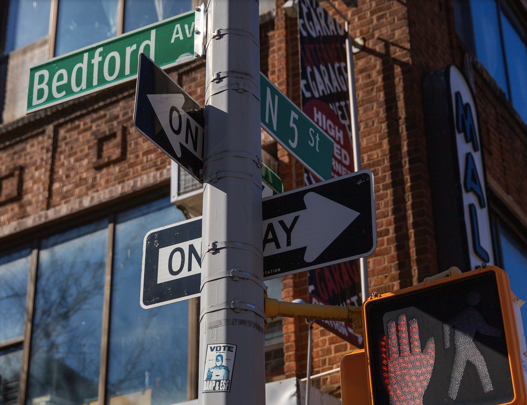 Williamsburg Street Signs a close up of a street sign in front of a building